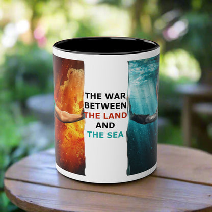 A mug features a graphic split design  and the text 'THE WAR BETWEEN THE LAND AND THE SEA' in black, red, and blue lettering.